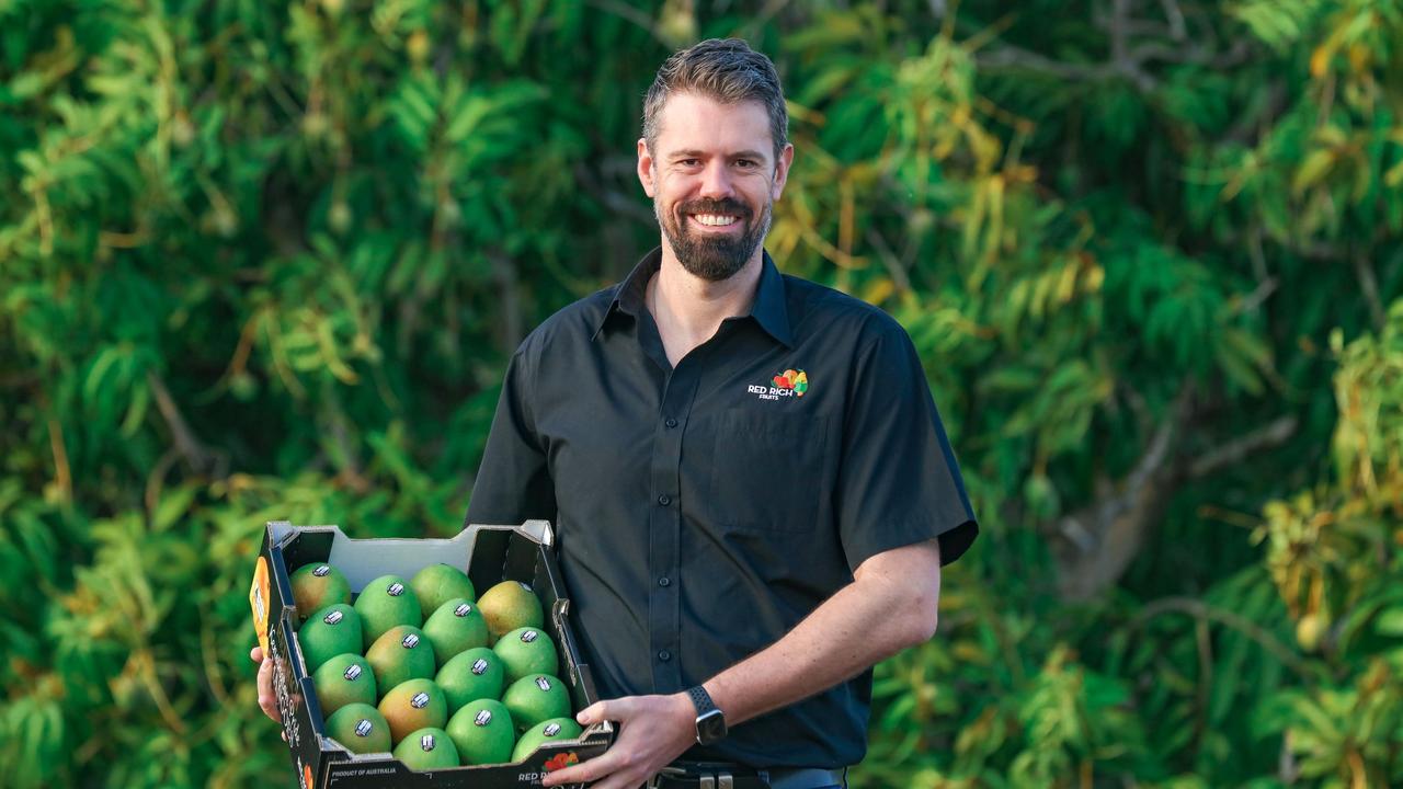 Matthew Palise from Red Rich Fruits with a box of mangoes