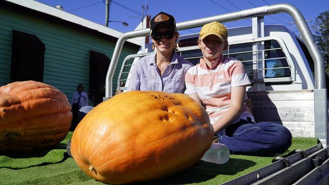 Lovisa and Bella Heeb with Bella's winning 25kg pumpkin she started growing in Janruary at the Goomeri Pumpkin Festival 2024