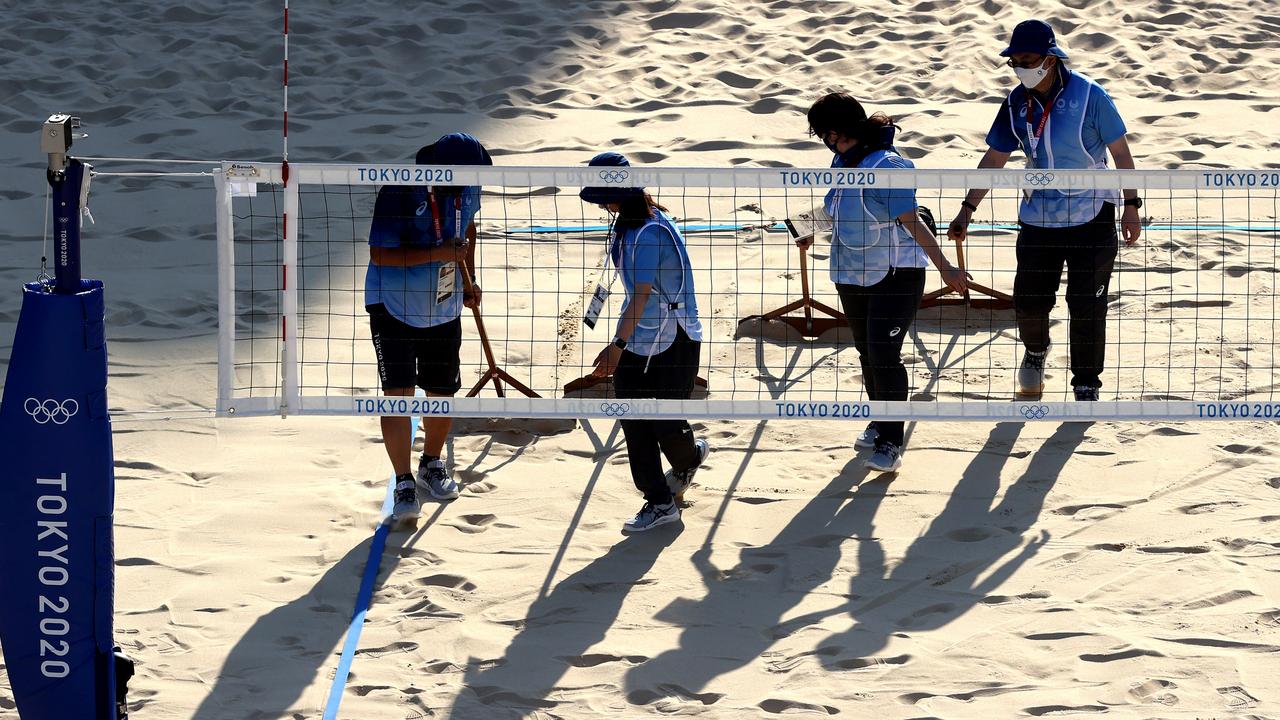 Workers prepare the Beach Volleyball court prior to a training session at Shiokaze Park. Picture: Sean M. Haffey