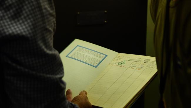 NT Heritage Branch director Michael Wells with a 1985 ledger found in the long-locked vault. Picture: Justin Kennedy