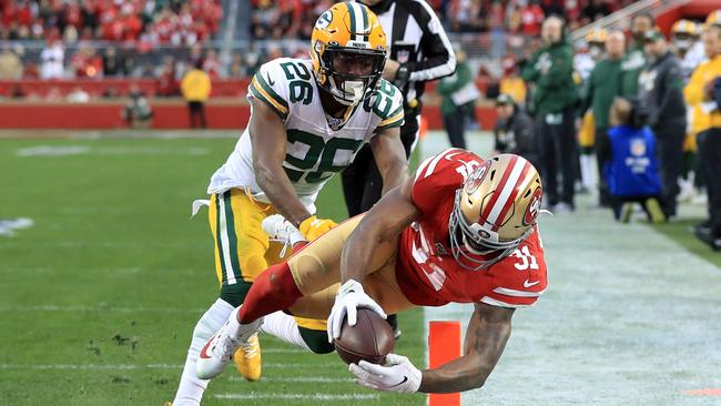 San Francisco 49ers running back Raheem Mostert dives for one of four touchdowns