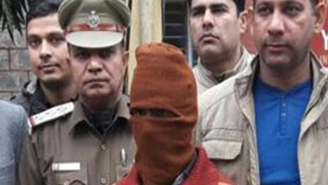 Sunil Rastogi is led into court while wearing a mask at the weekend.