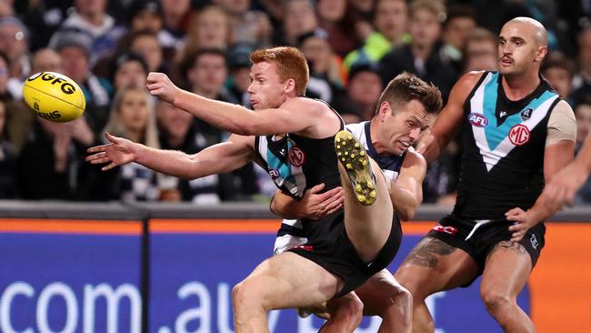 Port Adelaide midfielder Willem Drew is tackled by Geelong’s Shaun Higgins on Thursday night. Picture: Sarah Reed/AFL Photos