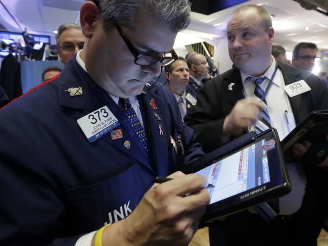 Trader John Panin, left, works on the floor of the New York Stock Exchange, Thursday, Oct. 29, 2015. Stocks are edging lower Thursday morning, giving back some of the gains they made the day before. (AP Photo/Richard Drew)
