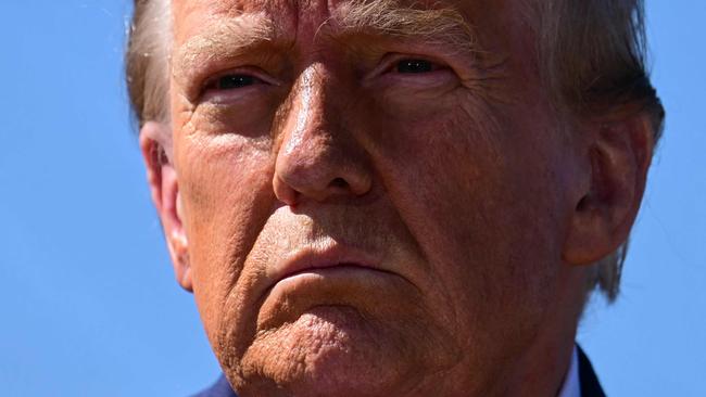 TOPSHOT - Former US President and Republican presidential candidate Donald Trump speaks to the media in Swannanoa, North Carolina, on October 21, 2024, after observing cleanup efforts in the aftermath of Hurricane Helene, which devastated the region. (Photo by Jim WATSON / AFP)