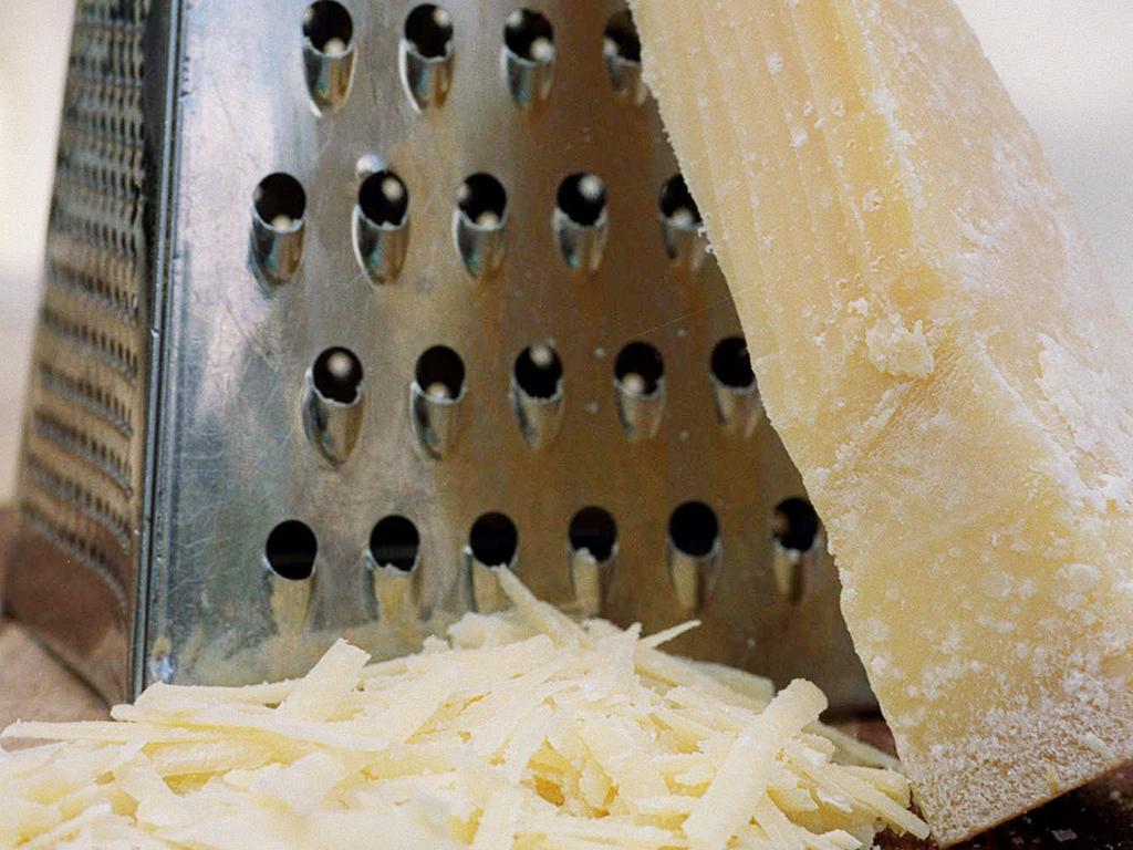 Cheese with grater and grated cheese. 19 Jun 2000. / food   / dairy - archived