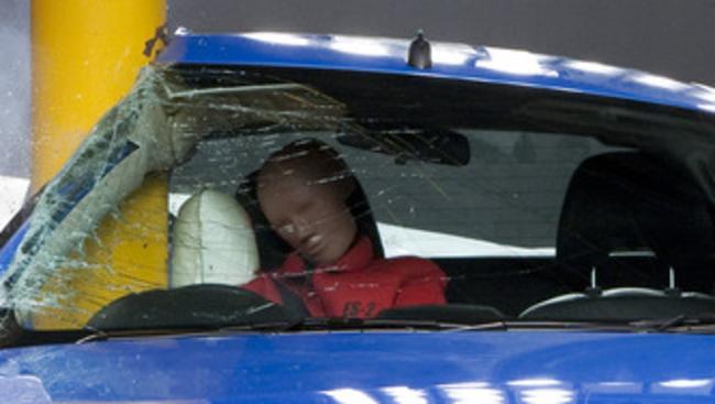 Photo of a Ford Falcon undergoing a pole crash test. The side airbag, which deploys from the seat, protects the driver's head and torso.