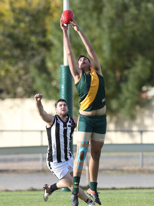 Marion’s Cameron Watts marks during the third quarter against Reynella on Saturday. Picture: Stephen Laffer