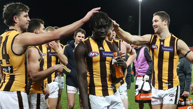 Changkuoth Jiath of the Hawks celebrates victory after the first AFL game played in snow in Canberra. Picture: Getty Images