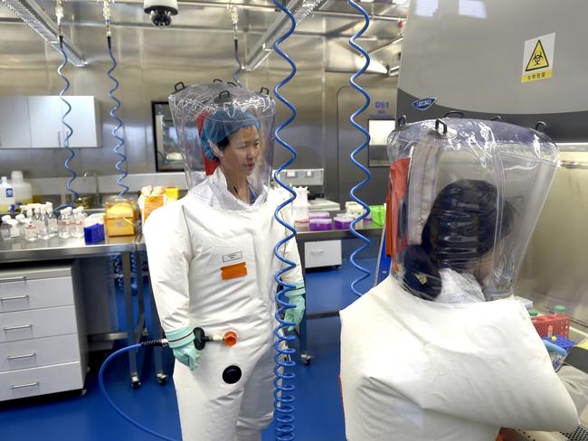 Virologist Shi Zheng-li, left, works with her colleague in the P4 lab of Wuhan Institute of Virology (WIV) in Wuhan. Picture: Getty Images