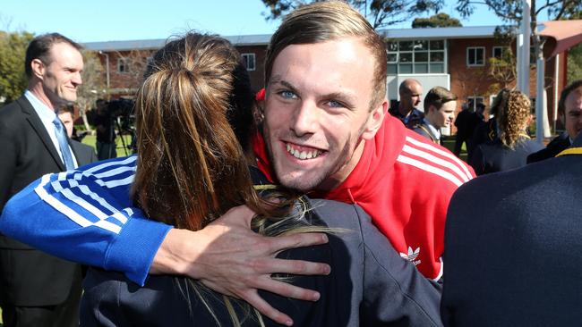 Chalmers hugs a schoolmate during a visit to Immanuel College. Photo: Calum Robertson