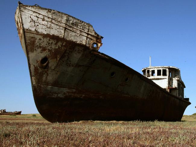 The rusting brown shell of a one time cargo ship lies in what was once a bay in the Aral Sea near the village of Zhambul, 21/06/2007. The Aral Sea, once the size of Ireland has, due to disastorous Soviet Union irrigation sytems, decreased to about a quarter its size with experts predicted it would disappear completely by 2020.