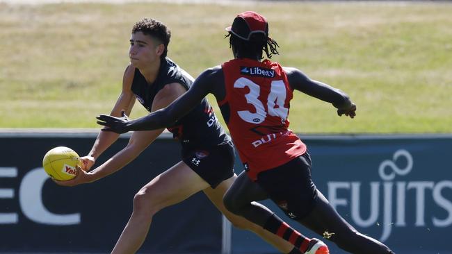 Elijah Tsatas dishes out a handball. Picture: Michael Klein