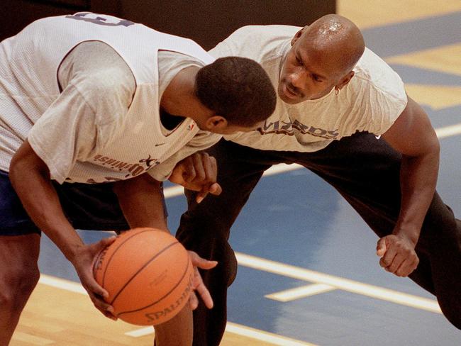 F363937 04: Washington Wizards co-owner Michael Jordan, right, practices with player Laron Profit during practice at MCI Center in Washington, DC January 31, 2000. (Photo by Mario Tama)