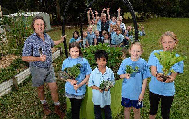 GREEN THUMBS: Pat Greene and the children of Goolmangar Primary School are preparing for the garden competition with the Lismore Garden Club. Students at the front are Odessa Smith, Christian Hertz, Audrey Jones and Cieda Ritchi-jol. At the back with the rest of the school are Charlie and Dorothy Cox, judges of the competiton. Picture: Mireille Merlet-Shaw