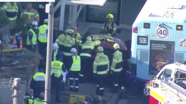 Two in hospital after car crashes into Sydney bus stop (9NEWS)