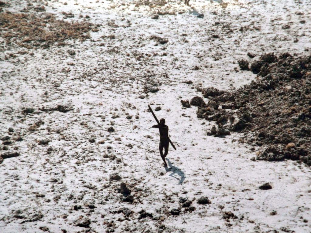 A man with the Sentinelese tribe aims his bow and arrow at an Indian Coast Guard helicopter as it flies over North Sentinel Island in the Andaman Islands. Chau wanted to convert the tribe to Christianity to bring on the End of Days. Picture: AFP