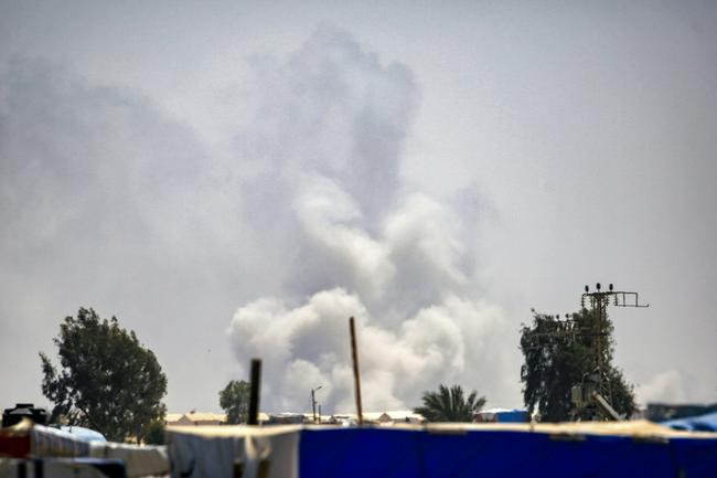 Smoke plumes billow near tents sheltering displaced Palestinians in Rafah in the southern Gaza Strip on June 4, 2024