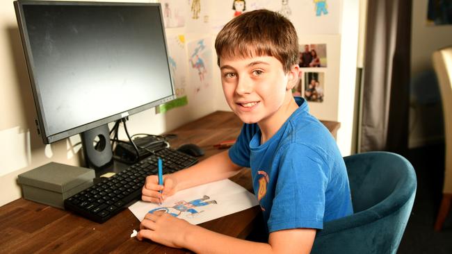 Henry Dray 7, battles with the rare disease Dup15q. His brother William Dray 10 (pictured) draws superheroes for those who donate. Picture: Alix Sweeney