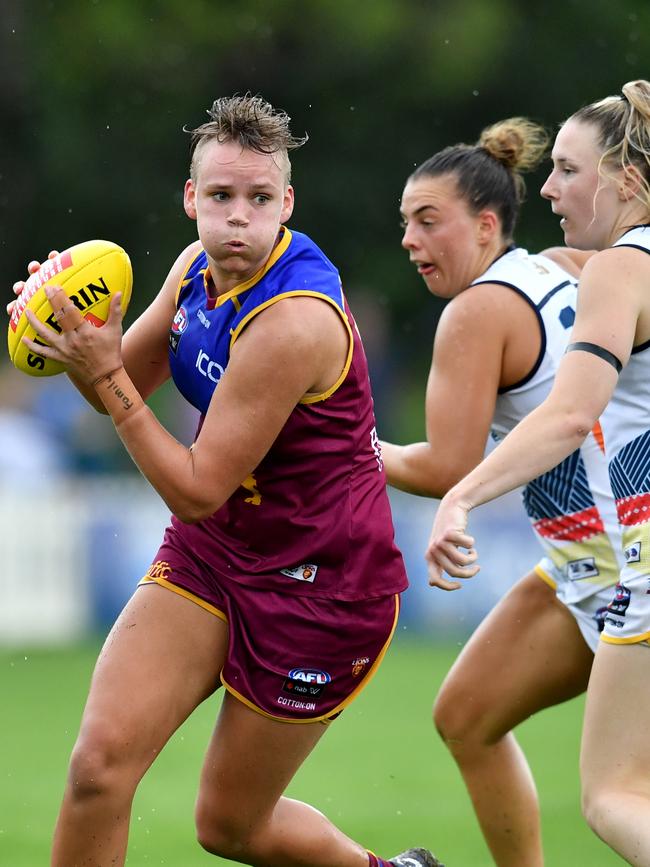 Brisbane’s Dakota Davidson (left) skips clear of two would-be tacklers.