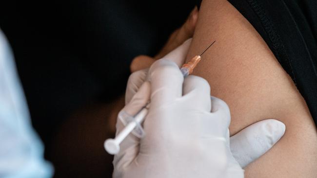 SYDNEY, AUSTRALIA - NewsWire Photos September 24, 2021: Medical staff administering COVID-19 Vaccinations at the Drive-Through COVID-19 Vaccination Hub at Belmore Sports Ground, Sydney. Picture: NCA NewsWire / James Gourley