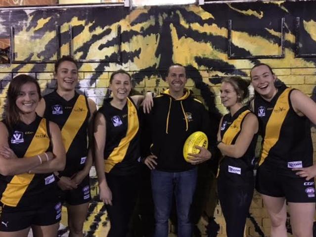 Seaford women's football coach Brett Alexander with players, from left, Claire Weiss, Kate Gillespie-Jones, Alice Rogers, Tilly Heming and Maddy Tilley.