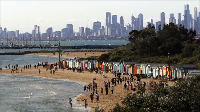 People enjoy the first day of daylight savings on Brighton Beach in Melbourne. Picture: David Crosling