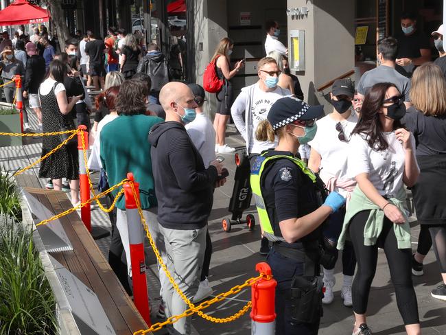 Police move among the crowds along Domain Rd on Saturday morning. Picture: David Crosling