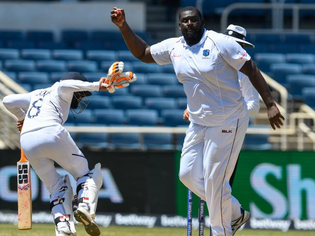 Ravindra Jadeja (L) of India takes evasive action as Rahkeem Cornwall (R) of West Indies takes a return catch during day 2 of the 2nd Test between West Indies and India at Sabina Park, Kingston, Jamaica, on August 31, 2019. (Photo by Randy Brooks / AFP)