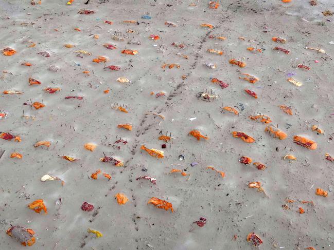 SHRINGVERPUR, INDIA - MAY 20: (EDITOR'S NOTE: Image depicts death.) Bodies, some of which are believed to be Covid-19 victims, are seen partially exposed in shallow sand graves after rains washed away the top layer of sand at a cremation ground on the banks of the Ganges River on May 20, 2021 in Shringverpur, northwest of Allahabad, Uttar Pradesh, India. Gravediggers at the site said that there was a threefold increase in the number of bodies arriving for burials and cremations since April. Teams of police and local officials have been patrolling several areas along the river in Uttar Pradesh and Bihar to discourage burials on its banks, and to warn people of possible infection risks, local media reported. India's prolonged and debilitating wave of Covid-19 infections has reached deep into rural India, where the true extent of devastation may never be known because of a lack of widespread testing or reliable data. (Photo by Ritesh Shukla/Getty Images)