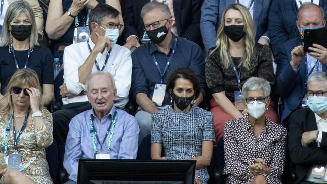 Tennis great Rod Laver, front row, second from left, and Virgin CEO Jayne Hrdlicka, third from left, at the Australian Open men’s final on Sunday night, with Labor leader Anthony Albanese sporting a Sydney Rabbitohs mask behind them with his girlfriend Jodie Haydon. Picture: Arsineh Houspian