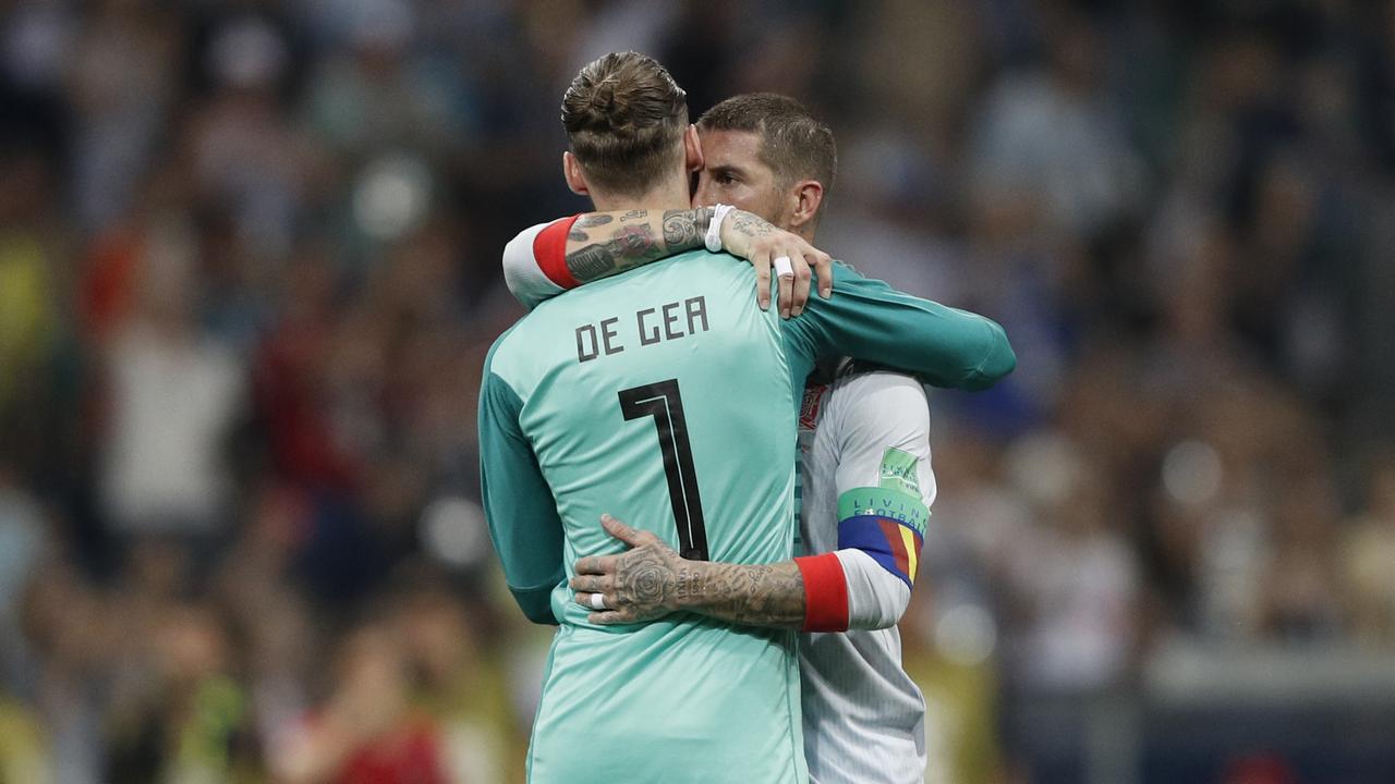 Spain's defender Sergio Ramos (R) hugs Spain's goalkeeper David De Gea