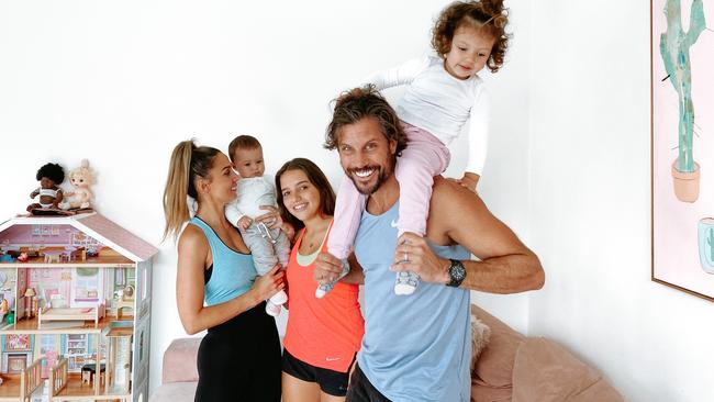 Sam Wood, his wife Snezana and daughters Charlie, Eve and Willow working out at their home in Melbourne.