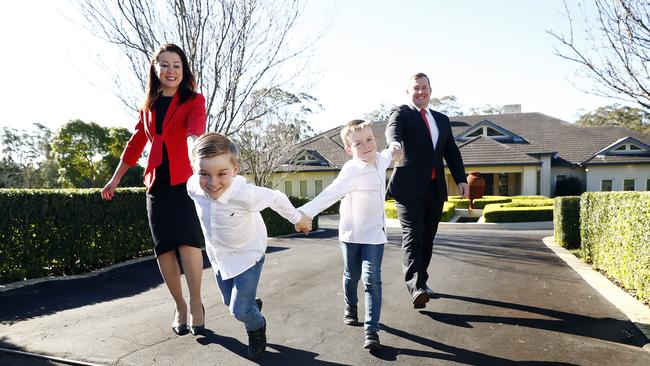 Will Hampson and Kate Lumby, with sons James and Lewis, outside a mansion on popular street Carters Rd in Dural. Picture: Sam Ruttyn