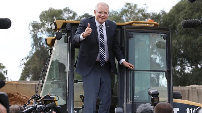 Prime Minister Scott Morrison greets waiting media at a garden centre in outer Melbourne yesterday. His government has started the election campaign exactly as the past five governments have — behind but with an early rise in support. Picture: Gary Ramage