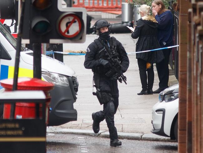 An armed specialist police officer responds at the scene of a fatal stabbing incident in central Glasgow. Picture: AFP