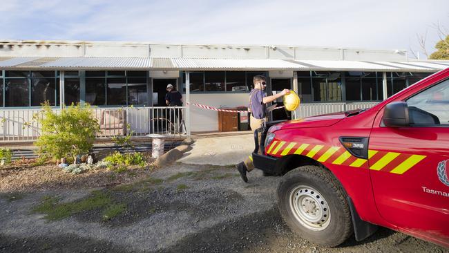 Investigators at the scene of the Kingston High School fire on Tuesday morning. Picture: RICHARD JUPE