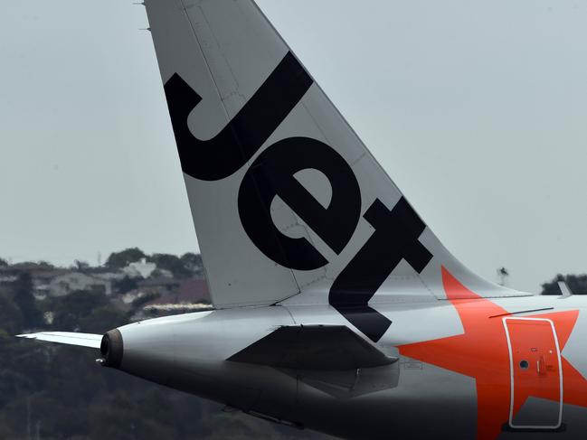 SYDNEY, AUSTRALIA - DECEMBER 12: A Jetstar aircraft tail is seen on arrival at Sydney airport on December 12, 2019 in Sydney, Australia. Jetstar has cancelled 108 upcoming flights between Friday and Sunday in preparation for pilots and ground staff to walk off the job for four hours on Saturday and Sunday amid stalled wage negotiations. (Photo by Sam Mooy/Getty Images)