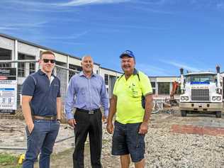 WIDE APPEAL: Jack Williams, left, with Rob Makara, right, and Glen Grimish of CBRE at Equinox Place, Bells Creek.