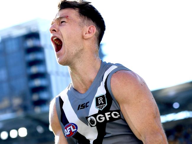 Robbie Gray roars after his stunning kick that sunk the Blues. Picture: Getty Images