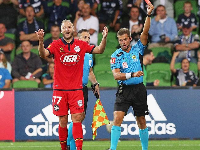 Dzengis Cavusevic of United is shown a red card by referee Alex King.