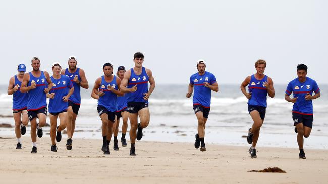 Western Bulldogs players run down the beach in Torquay. Picture: Michael Klein