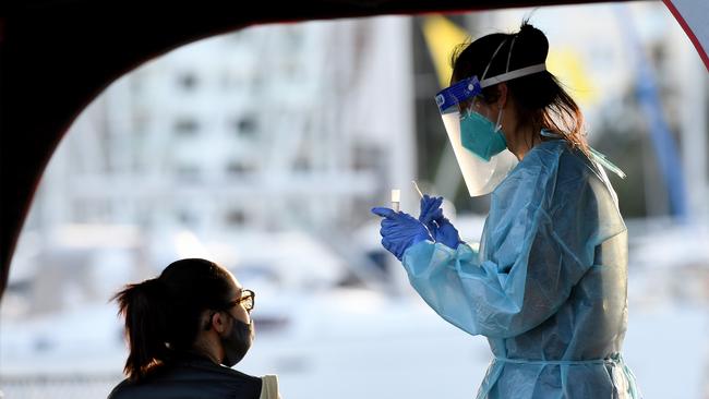 SYDNEY, AUSTRALIA - NCA NewsWire Photos JULY, 29, 2020: NSW Health workers dressed in Protection Equipment (PPE) are seen administering COVID-19 (Coronavirus) test at a pop-up testing clinic at Rushcutters Bay, in Sydney. A pop-up COVID-19 testing clinic in Rushcutters Bay Park has been established following the closure of the yacht club due after two visitors testing positive.Two people who dined at Thai Rock and the Apollo in Potts Point also visited the Cruising Yacht Club of Australia three times over July 23, 24 and 26. Picture: NCA NewsWire / Bianca De Marchi