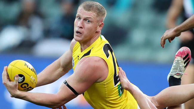 Josh Caddy fires out a handball against Port Adelaide. Picture: Sarah Reed