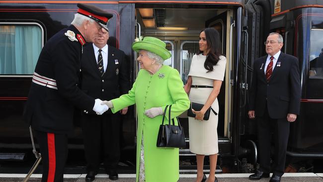 The Queen is greeted with Meghan, Duchess of Sussex as they arrive by Royal Train at Runcorn Station in 2018. Picture: Peter Byrne/WPA Pool/Getty Images