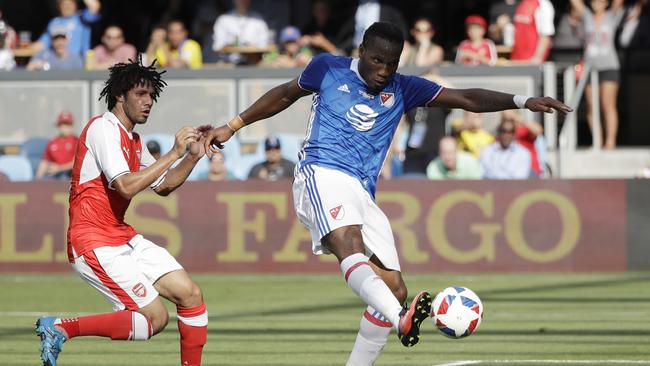 MLS All-Stars' Didier Drogba (R) scores next to Arsenal's Mohamed Elneny.