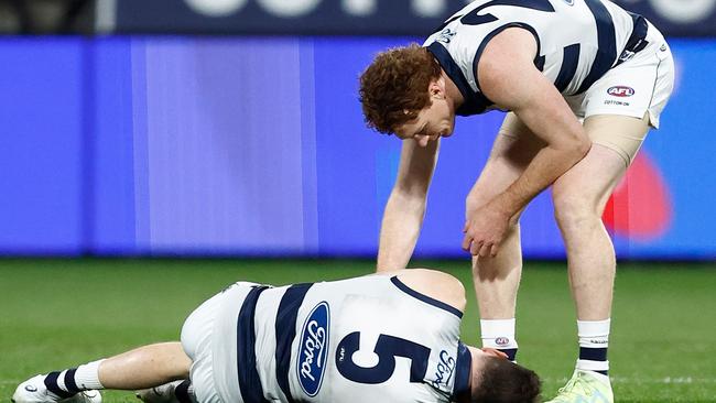 Gary Rohan checks on teammate Jeremy Cameron after their collision. Picture: Michael Willson/AFL Photos via Getty Images