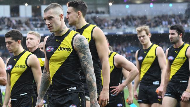 Dustin Martin leads Richmond off after losing to Geelong.