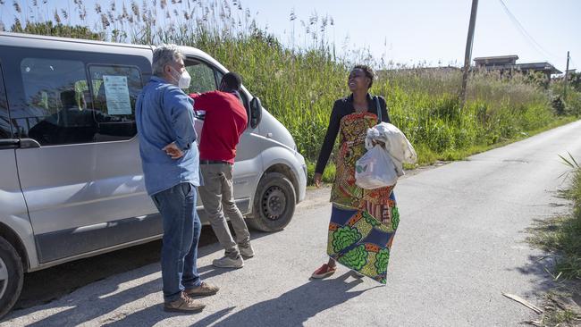 Daniele Moschetti talks with Mercy Fred, a woman from Nigeria, in Southern Italy. The undocumented African migrants who, even before the coronavirus outbreak plunged Italy into crisis, barely scraped by as day labourers, prostitutes and seasonal farm hands. PICTURE: AP Photo/Alessandra Tarantino