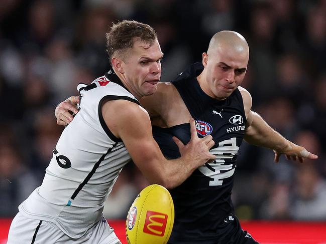 MELBOURNE, JULY 26, 2024: 2024 AFL Football - Round 20 - Carlton Blues V Port Adelaide Power at Marvel Stadium. Alex Cincotta of the Blues and Dan Houston of the Power  in action. Picture: Mark Stewart